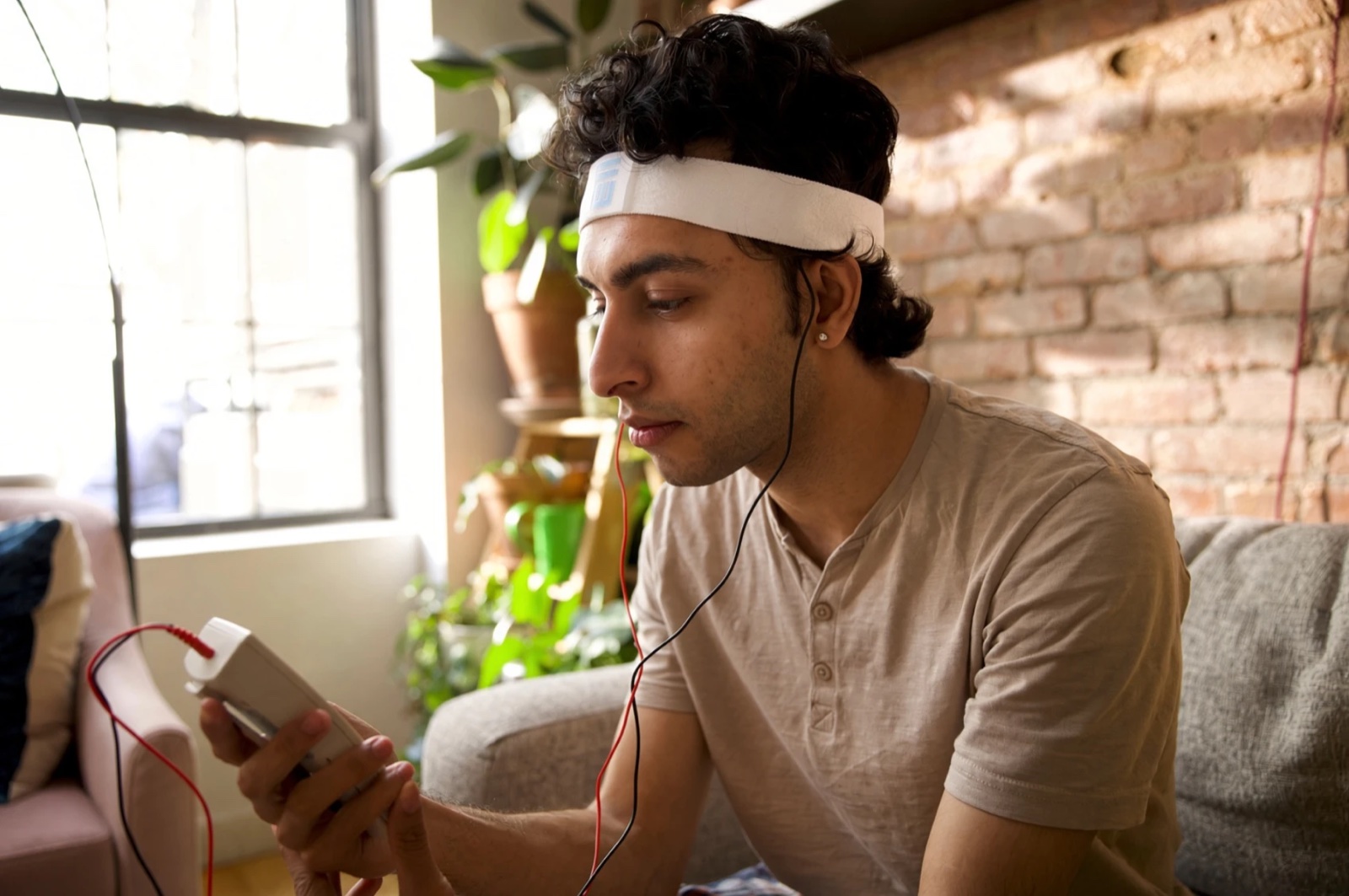 A man using the Fisher Wallace proof-of-concept device at home